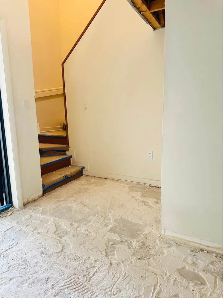 Stair landing with floor finishes scraped to the slab