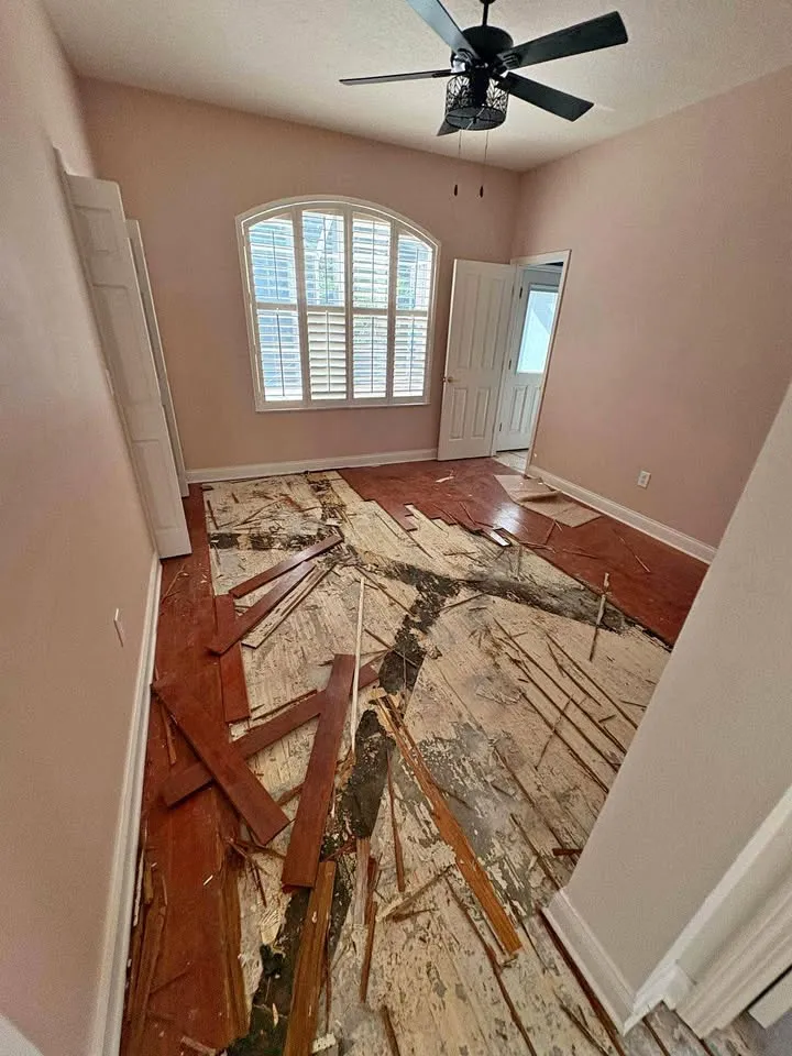 Bedroom with hardwood flooring torn up