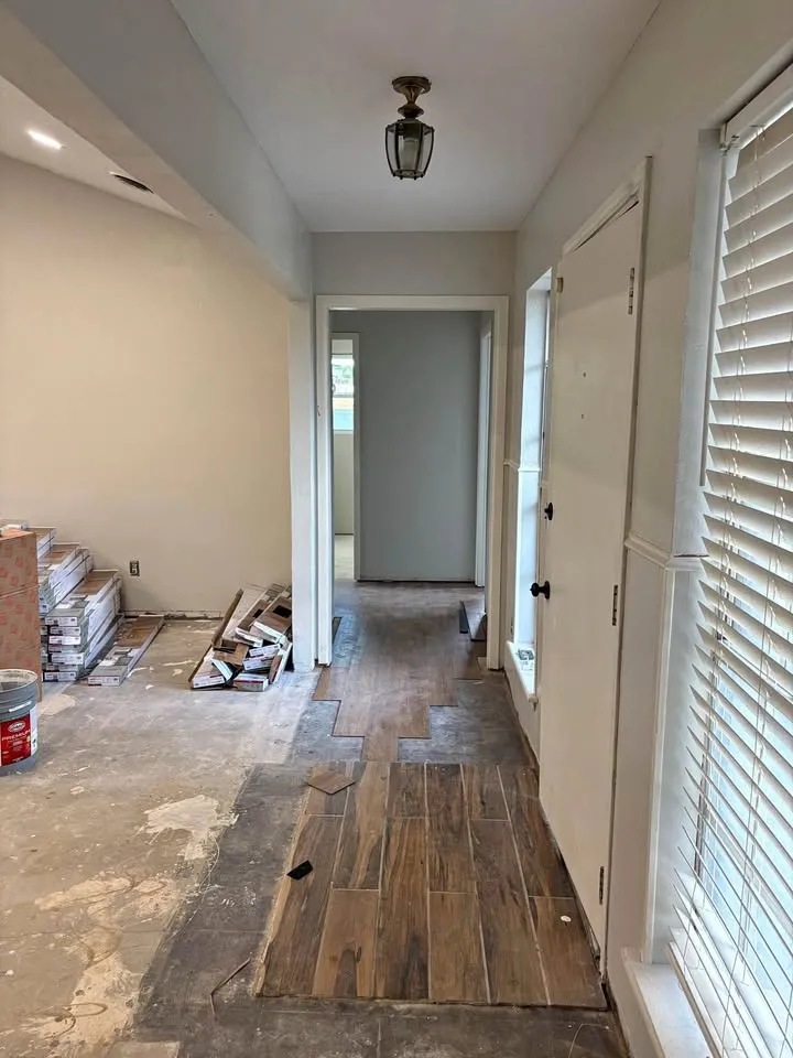 Hallway with flooring partly pulled up