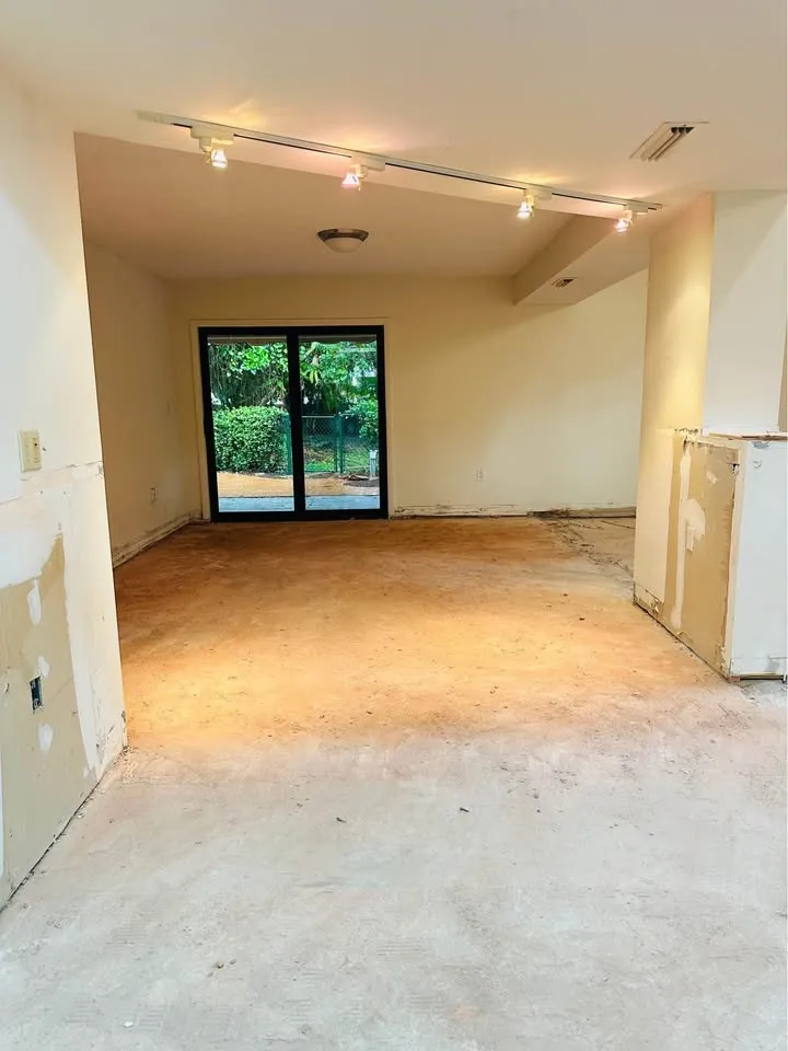 Long room with flooring pulled up down to the slab