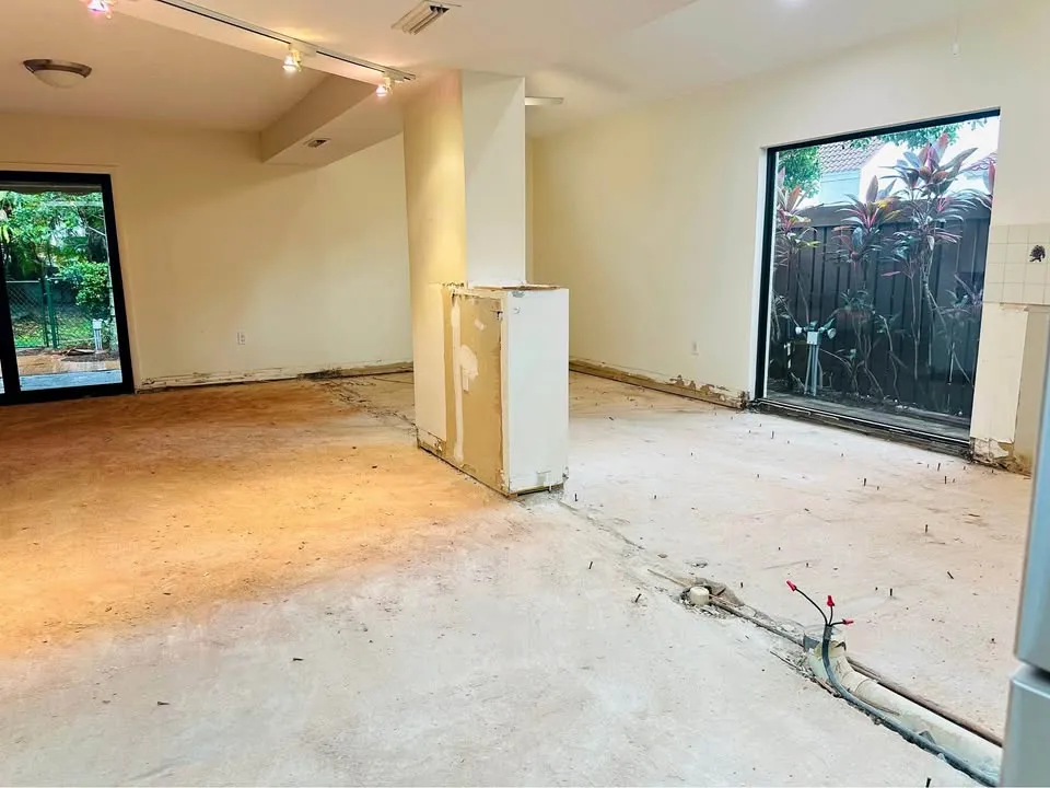 Bright room with flooring removed down to the slab