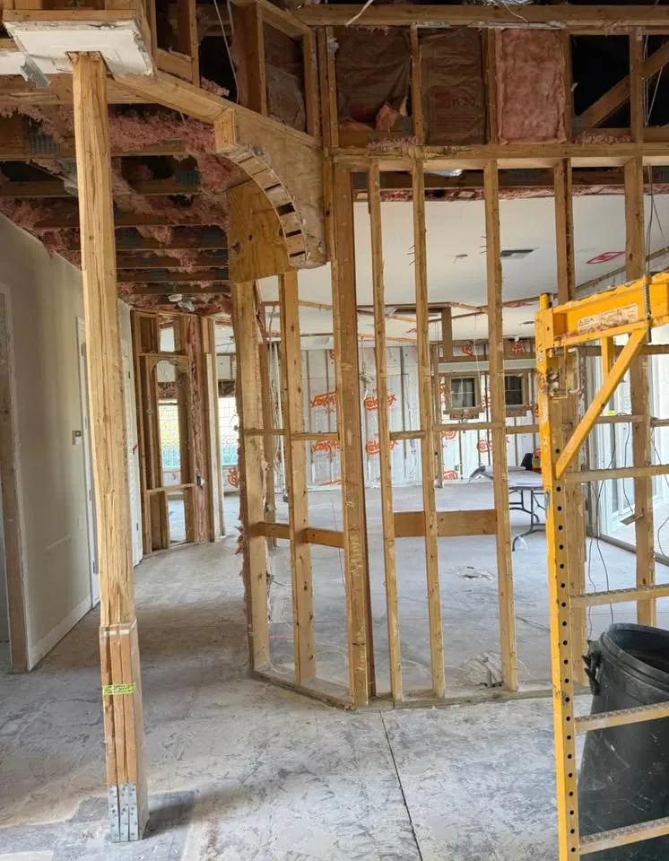 Curved interior wall stripped to its framing with the ceiling opened