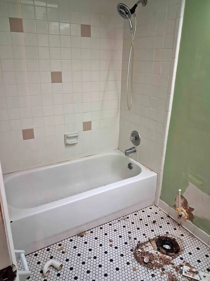 Bathroom with tub, wall tile and hexagon floor tile, toilet already removed