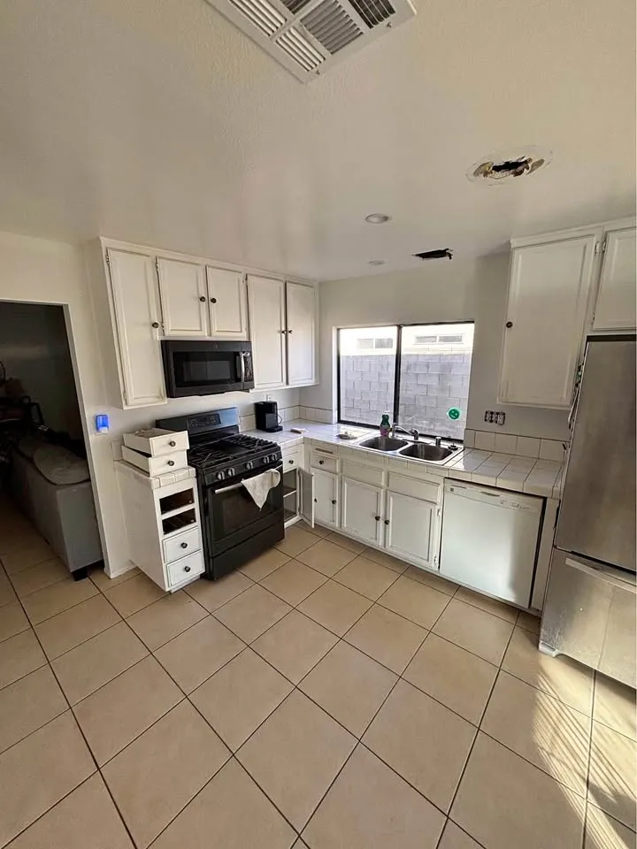 Kitchen with white cabinets and a tile floor