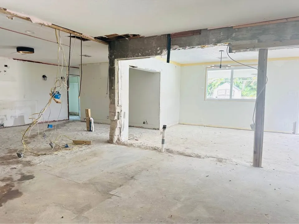 Open-plan area with a wall removed and a temporary support post in place