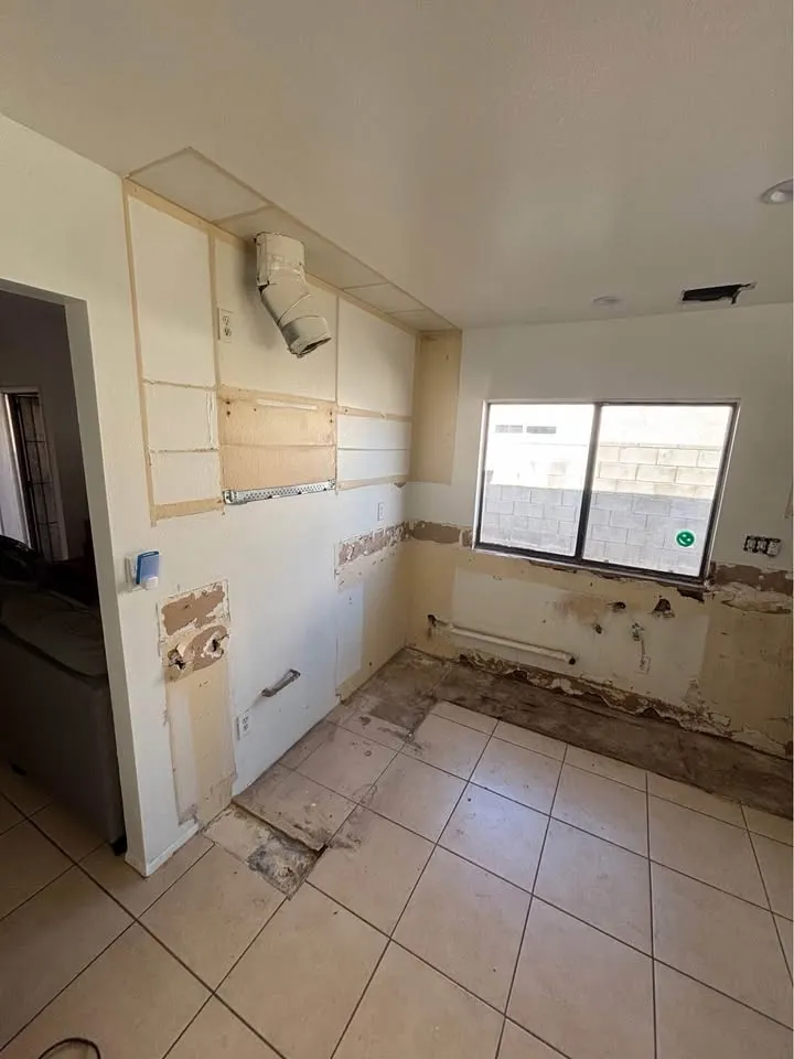 Kitchen with cabinets removed, their outline left on the walls