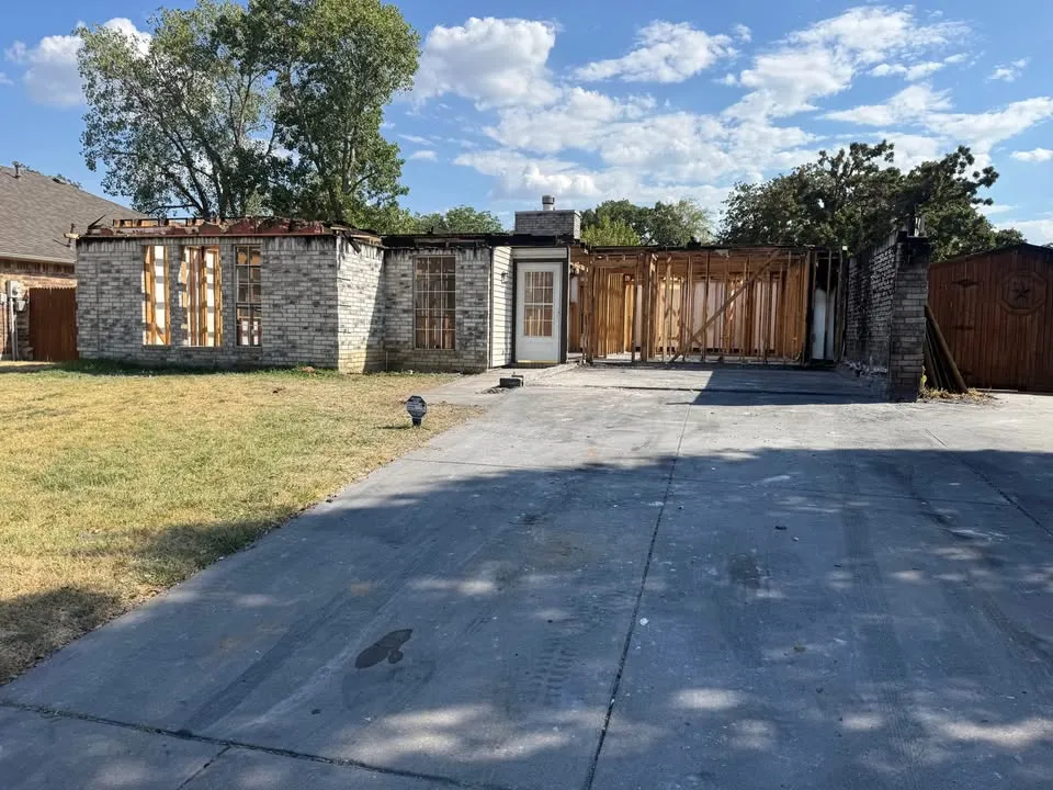 Single-storey brick house with the roof removed during a permitted residential demolition