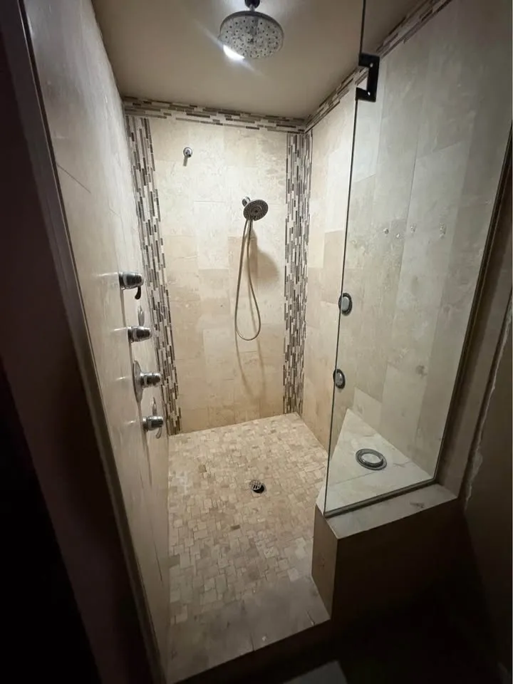Finished tiled walk-in shower with a glass door