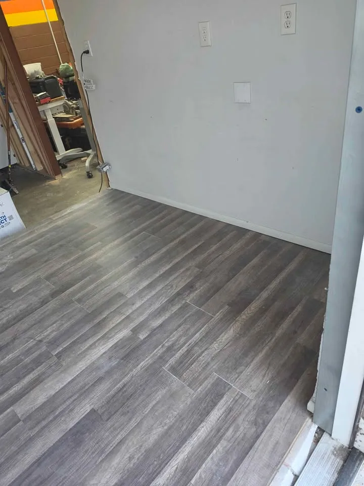 Room with new grey plank flooring installed